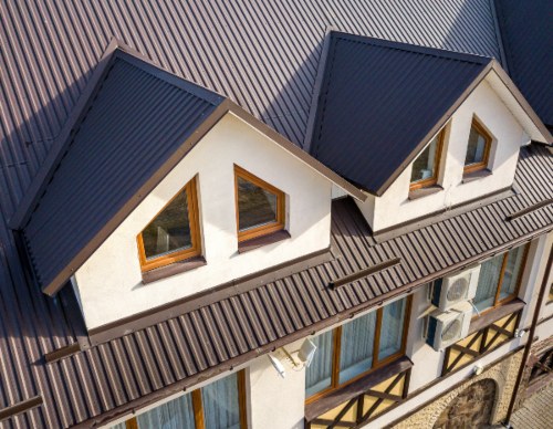 Close-up aerial view of a house with metal shingle roof