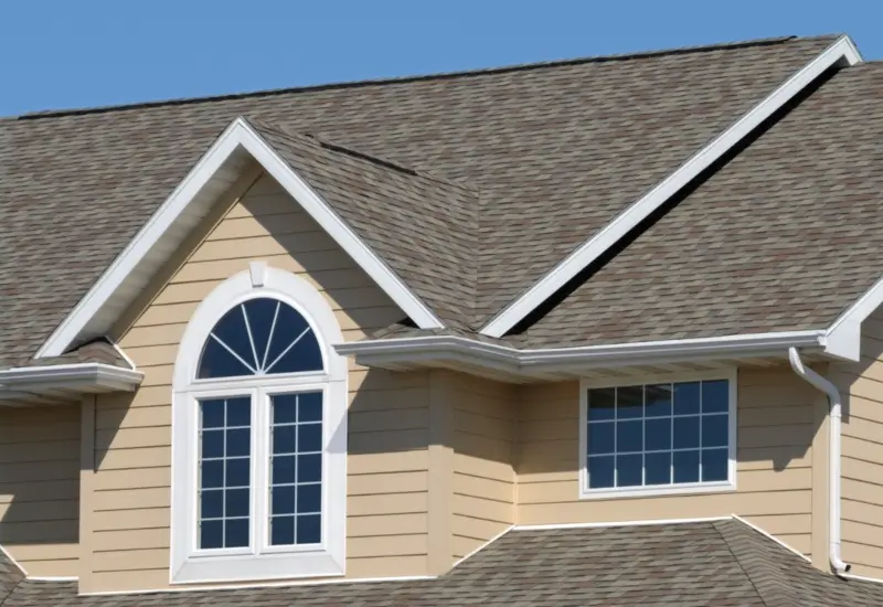 An asphalt roof on a tan home in Florida or the Alabama Panhandle