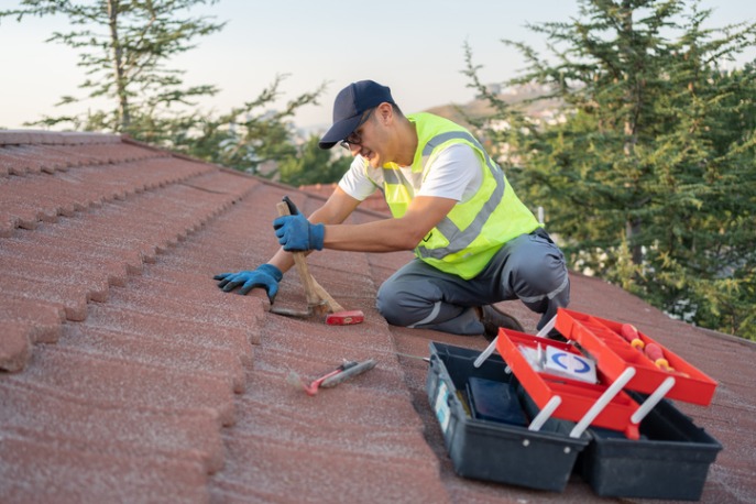 Close-up of tile roof repair during replacement by roofing expert