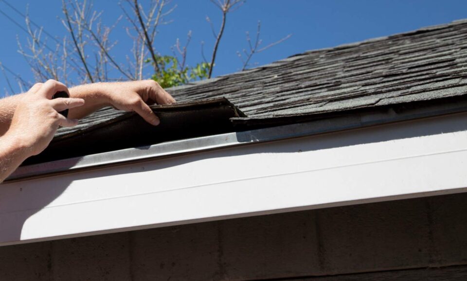 Homeowner reviewing roof damage documentation for an insurance claim in Montgomery, AL