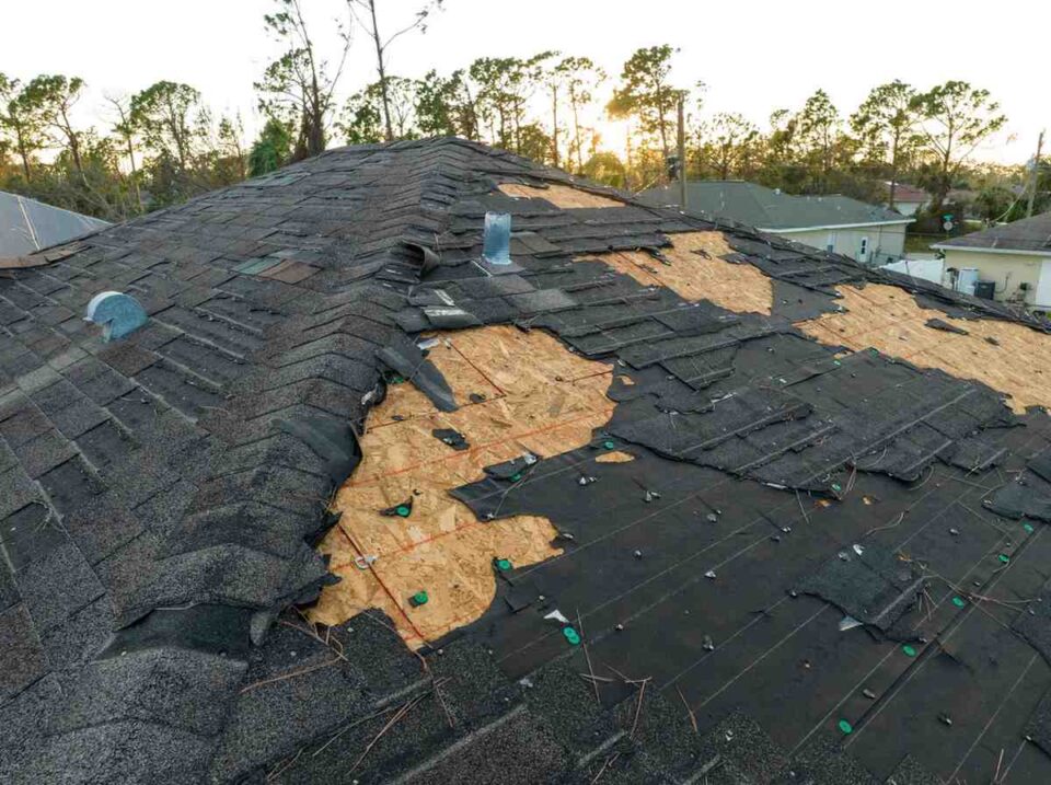 Wind-damaged roof with missing shingles after a severe storm in Montgomery, AL